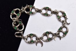 A WHITE METAL BRACELET, designed with eight oval shaped, openwork links, set with green stone
