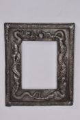 A LATE 19TH CENTURY ORIENTAL WHITE METAL PICTURE FRAME, embossed inner frame depicting dragons,