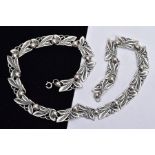 A 'BERNARD INSTONE' ARTS AND CRAFTS SILVER NECKLACE, designed with twenty openwork foliate and berry