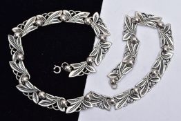 A 'BERNARD INSTONE' ARTS AND CRAFTS SILVER NECKLACE, designed with twenty openwork foliate and berry