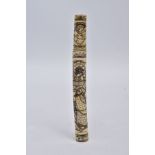 A JAPANESE CARVED BONE KNIFE CASE, the carved bone case decorated with an oriental scene and