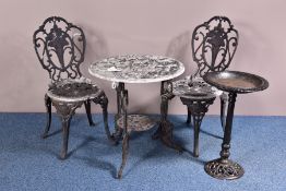 A CAST ALUMINIUM GARDEN TABLE AND TWO MATCHING CHAIRS, rose and foliage design, height of table 65cm