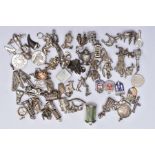 A QUANTITY OF SILVER AND WHITE METAL CHARMS, to include fifty six charms in various forms such as