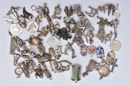 A QUANTITY OF SILVER AND WHITE METAL CHARMS, to include fifty six charms in various forms such as