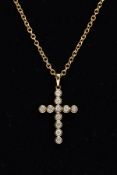 A 9CT GOLD DIAMOND PENDANT NECKLET, the pendant in the form of a cross, set with eleven round