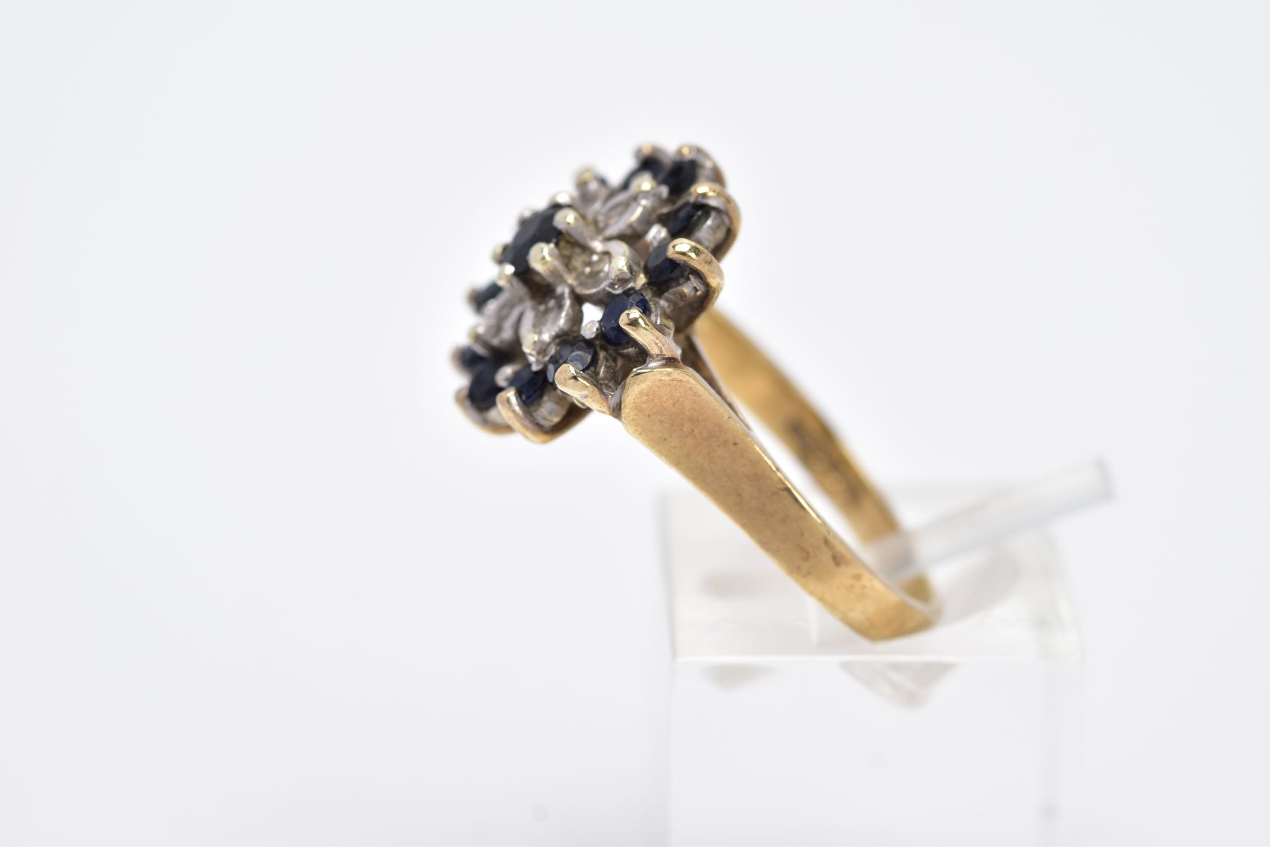 A 9CT GOLD SAPPHIRE AND DIAMOND CLUSTER RING, the raised cluster set with a claw set, circular cut - Image 2 of 4
