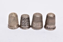 FOUR SILVER THIMBLES, of various designs, with hallmarks for Birmingham and Chester, approximate