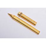 A GOLD PLATED CARTIER BALL POINT PEN, of an engine turn design, twisted tri-coloured detail to the