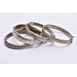 FOUR SILVER BANGLES, each decorated with an engraved foliate and scroll design, fitted with a push