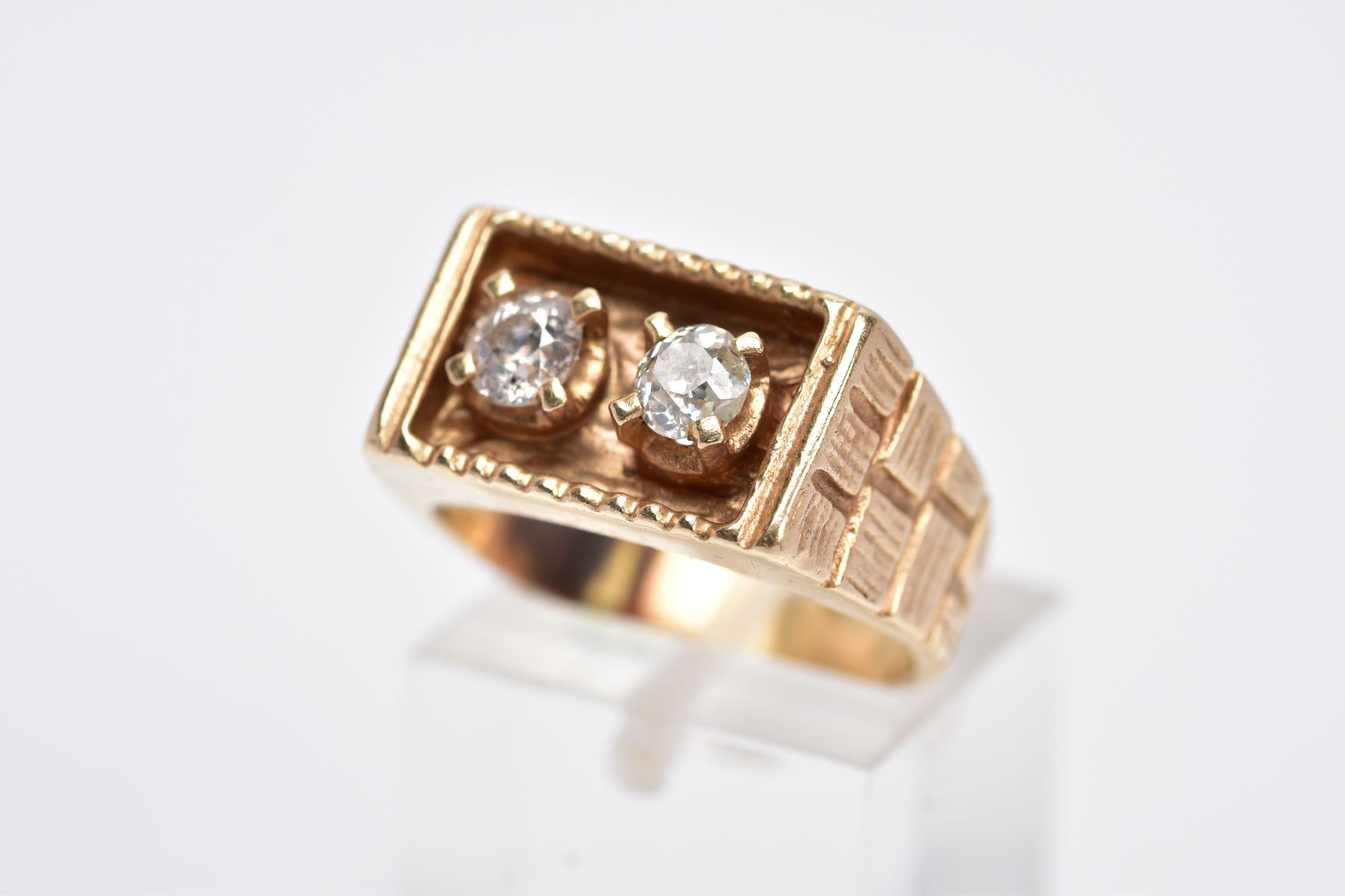 A YELLOW METAL DIAMOND SIGNET RING, of a rectangular design, with two claw set old cut diamonds,