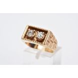 A YELLOW METAL DIAMOND SIGNET RING, of a rectangular design, with two claw set old cut diamonds,