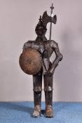 A LATE 20TH CENTURY DECORATIVE METAL FIGURE OF A KNIGHT WITH SHIELD AND POLEAXE, painted black,