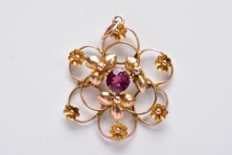 A YELLOW METAL OPENWORK PENDANT, in the form of an openwork flower set with a central circular cut