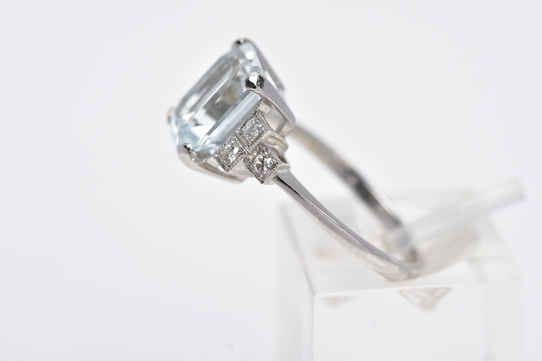 A WHITE METAL AQUAMARINE AND DIAMOND RING, designed with a central claw set, emerald cut aquamarine, - Image 2 of 4