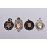 FOUR SILVER MEDAL FOBS, each of a circular form with vacant cartouches, two engraved to the