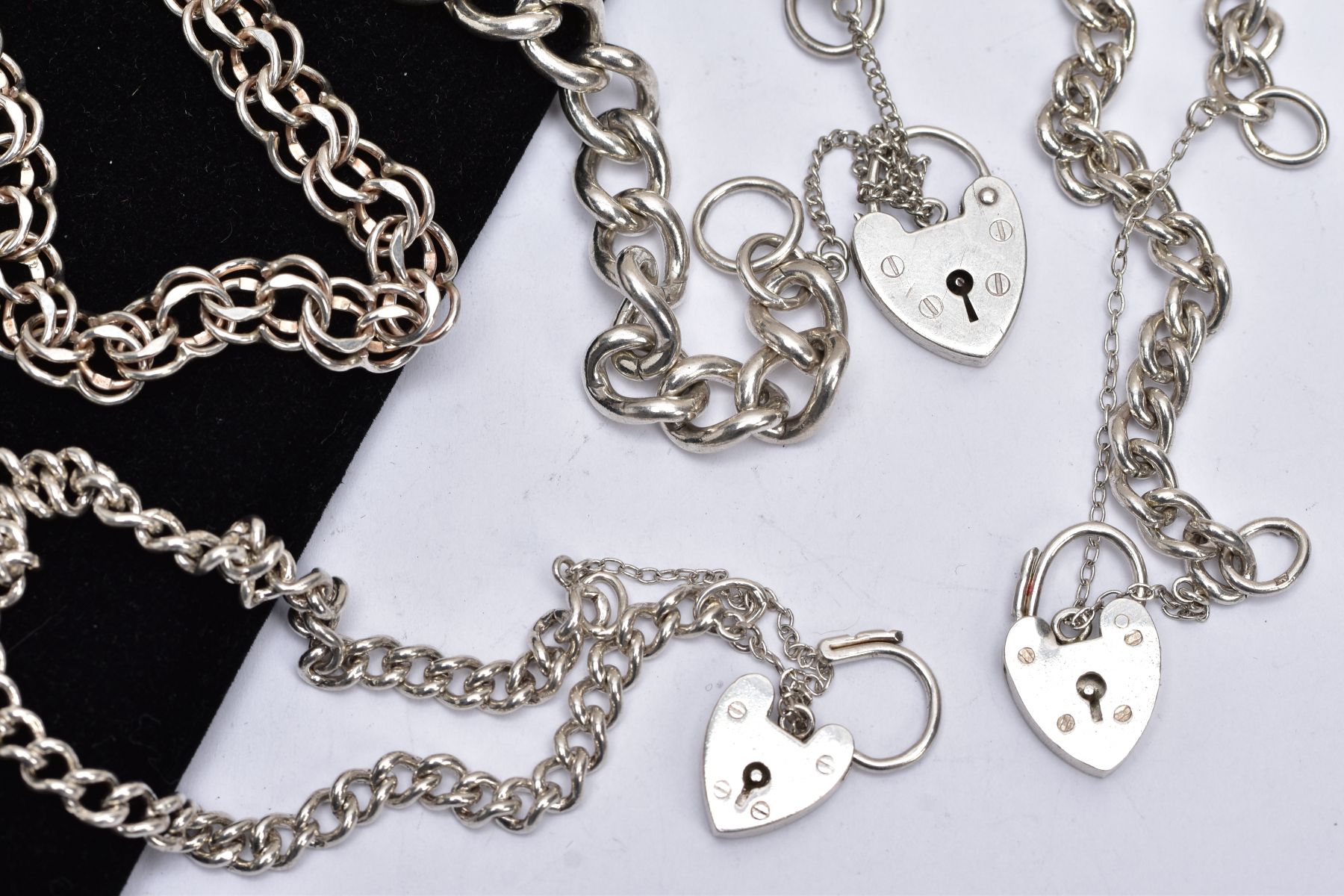 A BAG OF ASSORTED SILVER AND WHITE METAL CHARM BRACELETS, to include three curb link bracelets and - Image 3 of 3