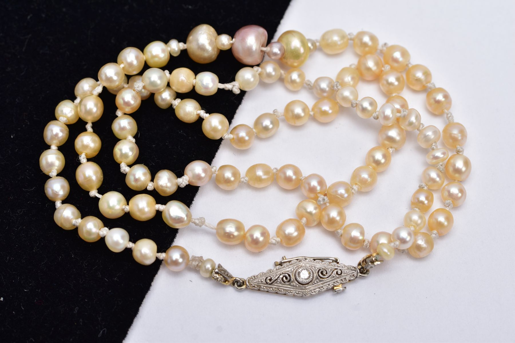 A FRESHWATER PEARL NECKLET, designed with a row of graduated pearls, fitted with yellow metal