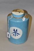 A CHINESE CRACKLE GLAZE TEA JAR/CANNISTER AND COVER, pale blue glaze, Chinese symbols to lid and