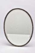 A SILVER FRAMED MIRROR, of an oval form, set with a textured frame, hallmarked 'William Comyns &