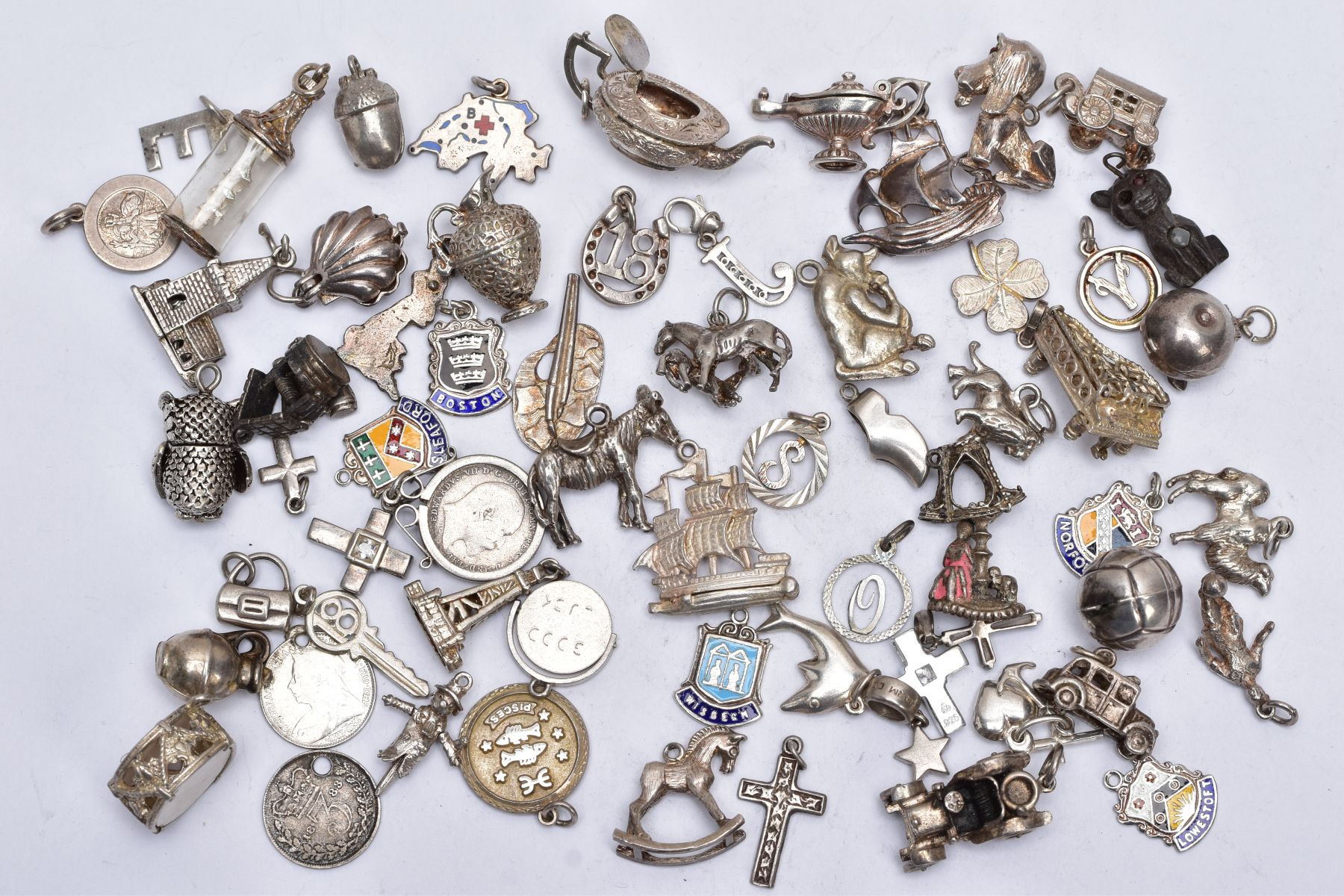 A BAG OF ASSORTED SILVER AND WHITE METAL CHARMS, to include sixty four charms in various forms