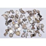 A BAG OF ASSORTED SILVER AND WHITE METAL CHARMS, to include sixty four charms in various forms