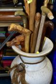 VARIOUS WALKING STICKS/SHOE HORN, housed in a large floorstanding vase, to include novelty metal