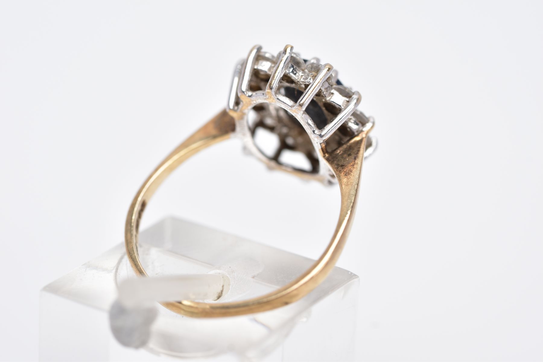 A 9CT GOLD CLUSTER RING, designed with a central oval cut blue sapphire, within a surround of claw - Image 3 of 4