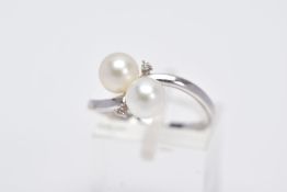 A 9CT WHITE GOLD RING, of a crossover design set with two cultured pearls flanked with round