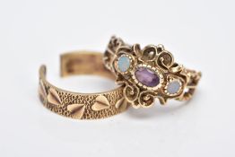 TWO 9CT GOLD RINGS, the first of a three stone design set with a central oval cut amethyst,