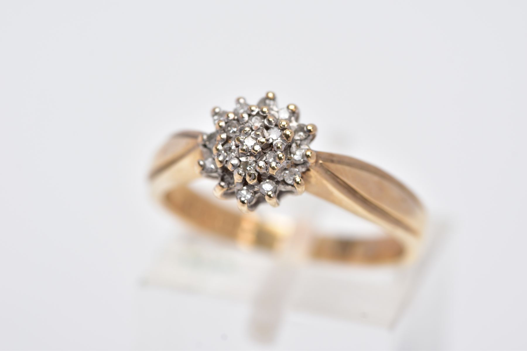 A MODERN 9CT GOLD DIAMOND CLUSTER RING, slightly raised cluster set with single cut diamonds,