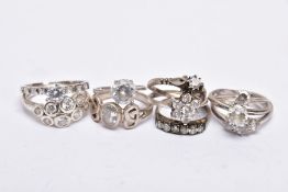 TEN WHITE METAL RINGS, to include single stone rings, cluster and a half eternity ring, each set