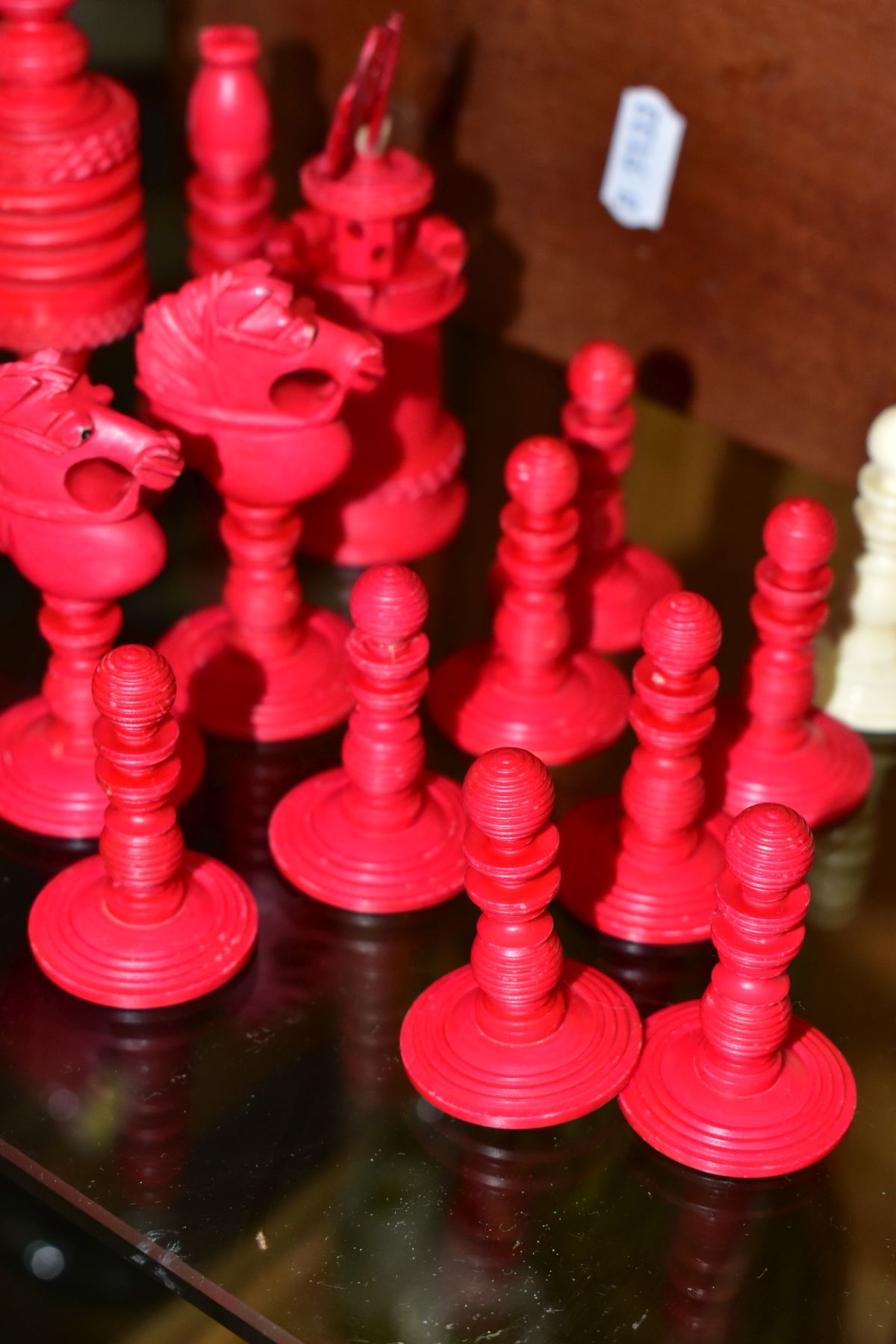 A 19TH CENTURY CARVED BONE SET OF CHESS PIECES, one half stained red, height king 14cm, with a baise - Image 4 of 7