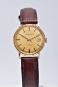 A 9CT GOLD GENTS 'ACCURIST' WRISTWATCH, hand wound movement, round gold dial signed 'Accurist, shock