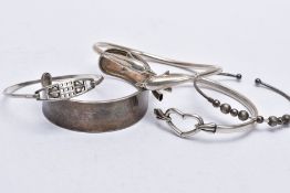 A BAG OF ASSORTED SILVER AND WHITE METAL BANGLES, the first silver bangle in the form of two