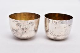 TWO 18TH CENTURY TUMBLECUPS, to include a plain polished design, engraved monogram, gilt interior,