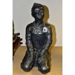 A CONTEMPORARY BRONZED CERAMIC SCULPTURE OF A GIRL KNEELING, wearing dungarees and her hair in a