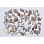 A BAG OF ASSORTED SILVER AND WHITE METAL CHARMS, to include fifty nine charms in forms such as a