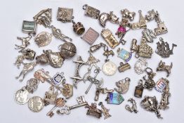 A BAG OF ASSORTED SILVER AND WHITE METAL CHARMS, to include fifty nine charms in forms such as a