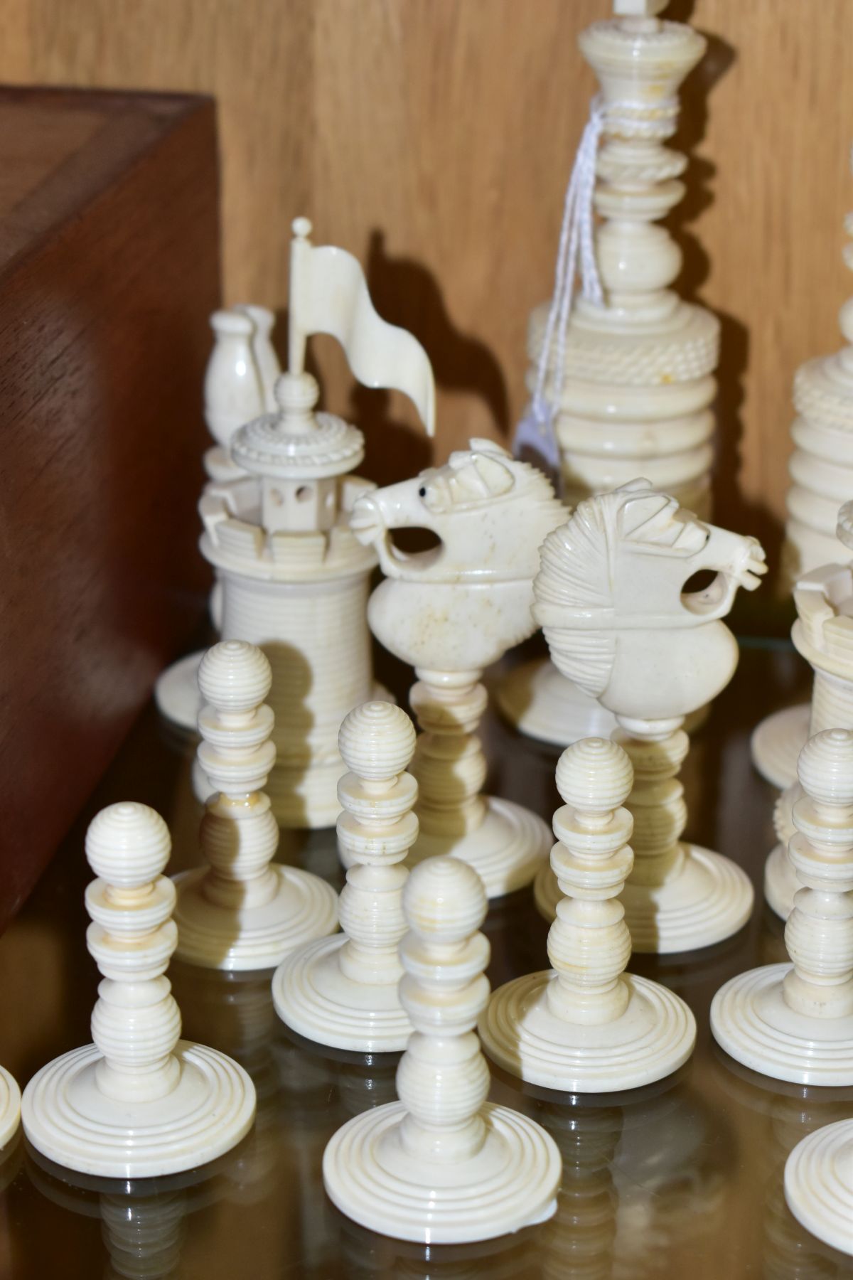 A 19TH CENTURY CARVED BONE SET OF CHESS PIECES, one half stained red, height king 14cm, with a baise - Image 6 of 7