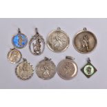 NINE SILVER AND WHITE METAL ST CHRISTOPHER PENDANTS, to include two circular pendants one fitted