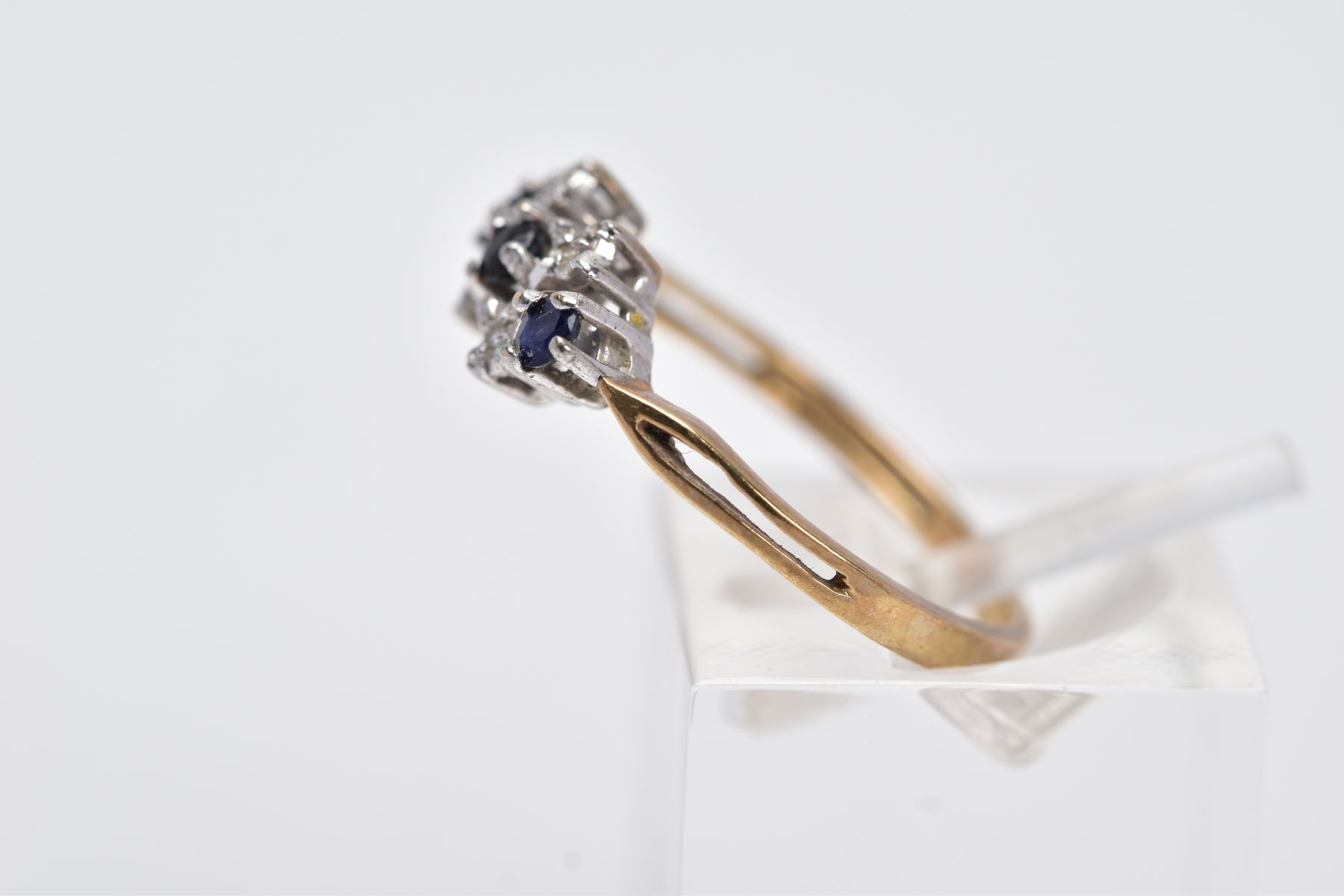 A 9CT GOLD SAPPHIRE AND DIAMOND RING, designed with a row of circular cut blue sapphires interspaced - Image 2 of 3