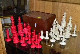 A 19TH CENTURY CARVED BONE SET OF CHESS PIECES, one half stained red, height king 14cm, with a baise