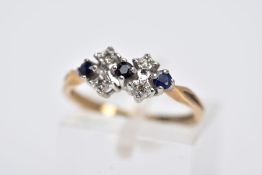 A 9CT GOLD SAPPHIRE AND DIAMOND RING, designed with a row of circular cut blue sapphires interspaced