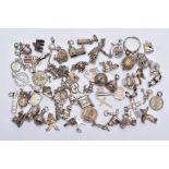 A QUANTITY OF SILVER AND WHITE METAL CHARMS, to include sixty charms in forms such as shoes, church,