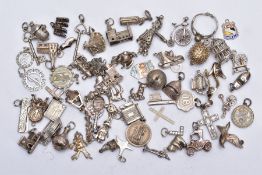 A QUANTITY OF SILVER AND WHITE METAL CHARMS, to include sixty charms in forms such as shoes, church,