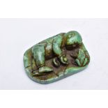 A CARVED GREEN HARDSTONE FIGURE, in the form of an Oriental figure beside a frog, a circular 'St