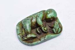 A CARVED GREEN HARDSTONE FIGURE, in the form of an Oriental figure beside a frog, a circular 'St