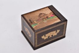 A JAPANESE NOVELTY CIGARETTE DISPENSER OF WOODEN CONSTRUCTION, the tambour lid slides to reveal a