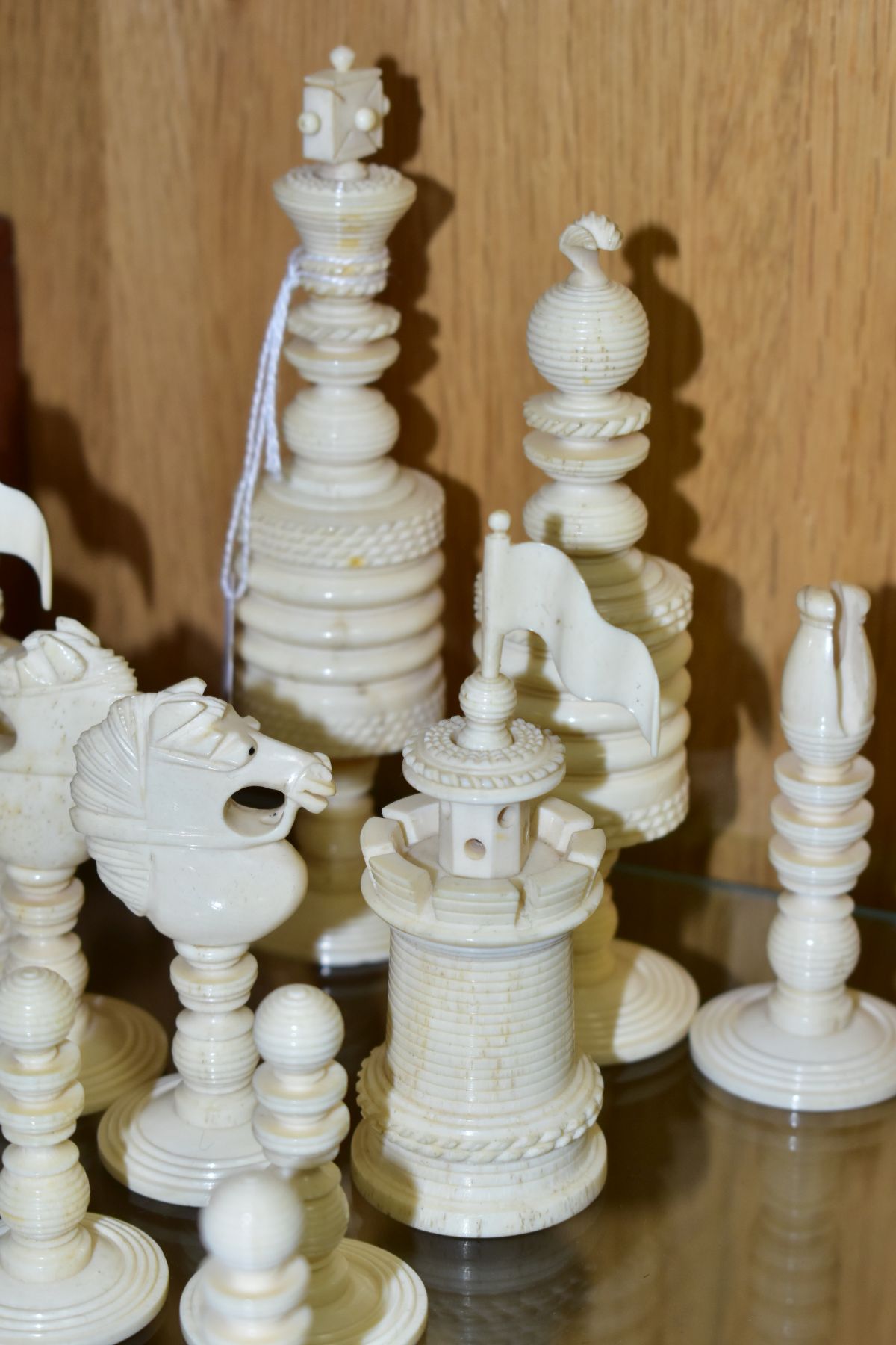 A 19TH CENTURY CARVED BONE SET OF CHESS PIECES, one half stained red, height king 14cm, with a baise - Image 7 of 7