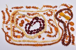 A TRAY OF AMBER AND CARVED IVORY BEAD NECKLACES AND A BROOCH, to include rough amber bead necklace